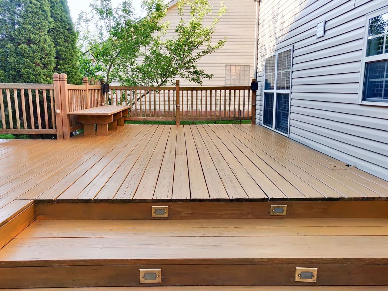 A finished wooden deck with railings